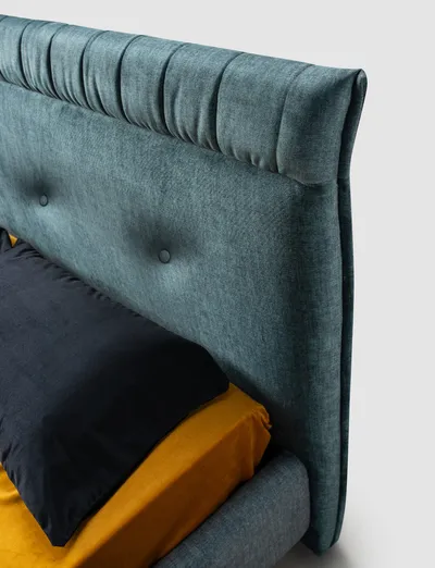 Detail of the SOREN bed's upholstered headboard