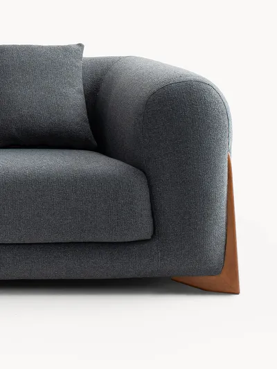 VIDAR sofa, close-up detail of the embracing armrest and wooden base