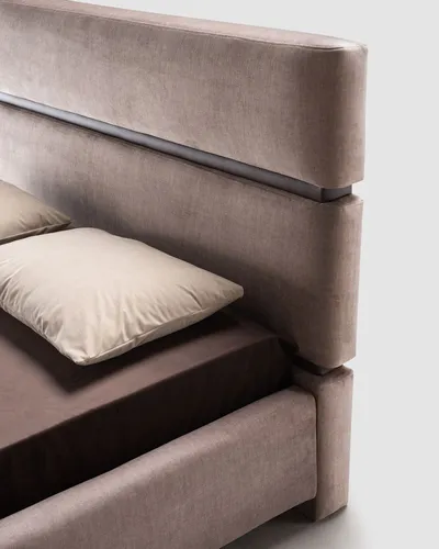 Detail of ASTON bed's double upholstered headboard with metallic insert