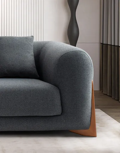 VIDAR sofa, detail of the sculptural armrest and wooden base in a luxury setting